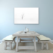 Load image into Gallery viewer, Out on the wintery snow-covered lake shore is a single solitary tree, with just two leaves left. Georgia Bay, Canada.