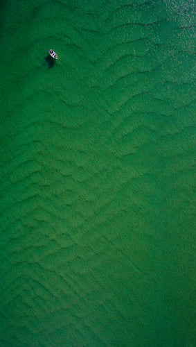 With this image I was drawn in by the simplicity of the composition, made unique by the sandy rippled patterns created in the shallow waters of this coastal inlet, Lake Conjola, NSW
