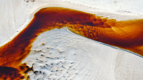 The mixing colours of stirred-up Tea Tree tannins and seashore shallows create a unique and original perspective, which can only be seen from above. Moona Moona Creek, Huskisson, NSW.