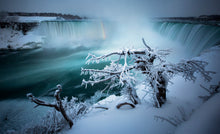 Load image into Gallery viewer, Niagara, Canada, this epic scene is made magical due to the hoarfrost crystals, formed when water vapour in the air has come into contact with the trees in the foreground, which are already below freezing point. Peter Izzard Photography Fine Art Print. 
